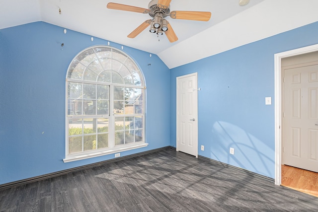 unfurnished room with ceiling fan, dark hardwood / wood-style flooring, and lofted ceiling