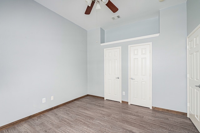 unfurnished bedroom featuring hardwood / wood-style floors and ceiling fan