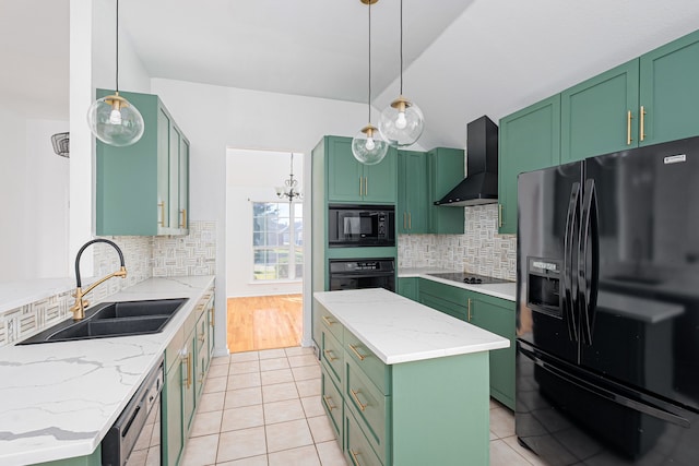 kitchen with a center island, wall chimney range hood, backsplash, black appliances, and green cabinetry