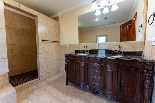 bathroom featuring vanity, tile patterned floors, ornamental molding, tile walls, and tiled shower