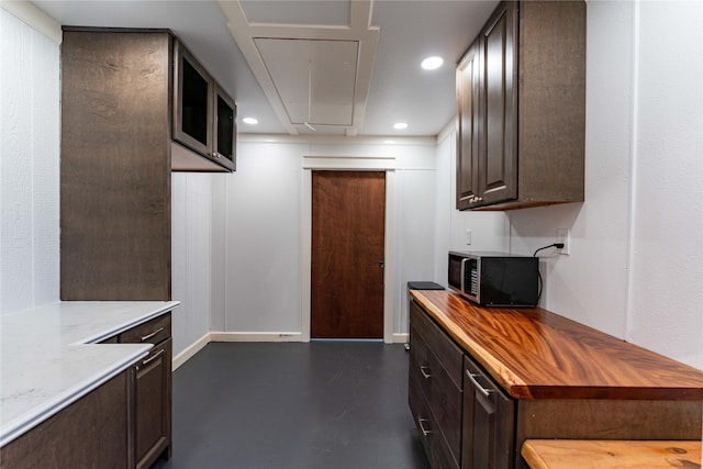 kitchen with dark brown cabinets and wooden counters