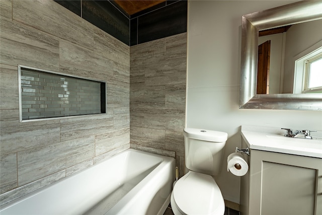 bathroom featuring a washtub, vanity, and toilet