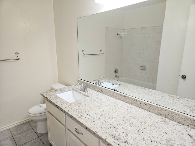 full bathroom featuring tile patterned floors, tiled shower / bath, vanity, and toilet