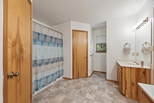 bathroom featuring vanity, a textured ceiling, and a shower with shower curtain