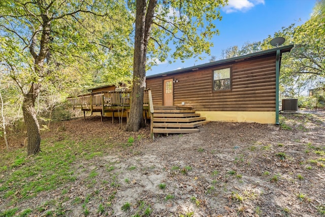 back of property with cooling unit and a deck