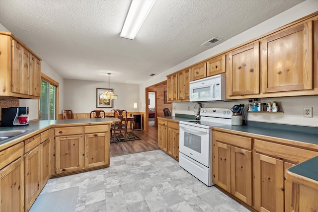 kitchen with white appliances, a textured ceiling, decorative light fixtures, light hardwood / wood-style floors, and kitchen peninsula