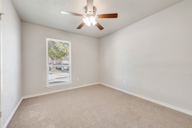 unfurnished room with ceiling fan and carpet floors