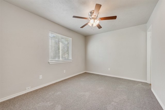 carpeted spare room with ceiling fan and a textured ceiling