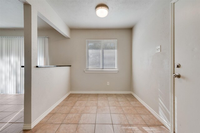 spare room featuring light tile patterned floors