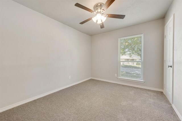 carpeted empty room featuring ceiling fan