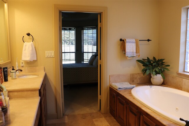 bathroom featuring a washtub and vanity