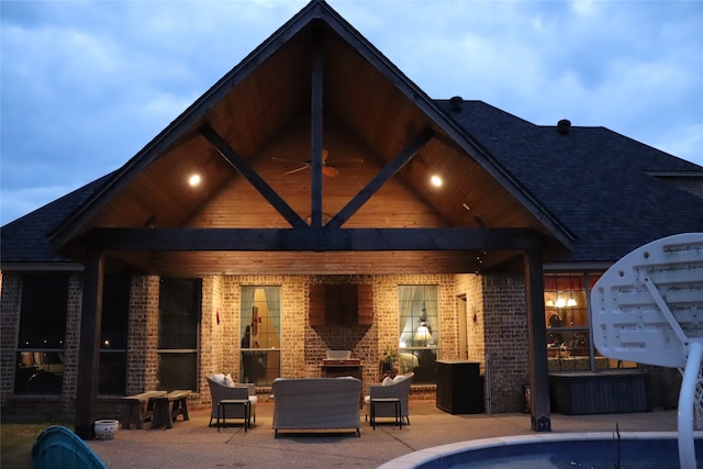 back of property featuring outdoor lounge area, ceiling fan, a swimming pool, and a patio