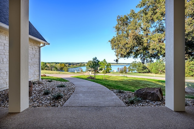 exterior space with a water view and a yard