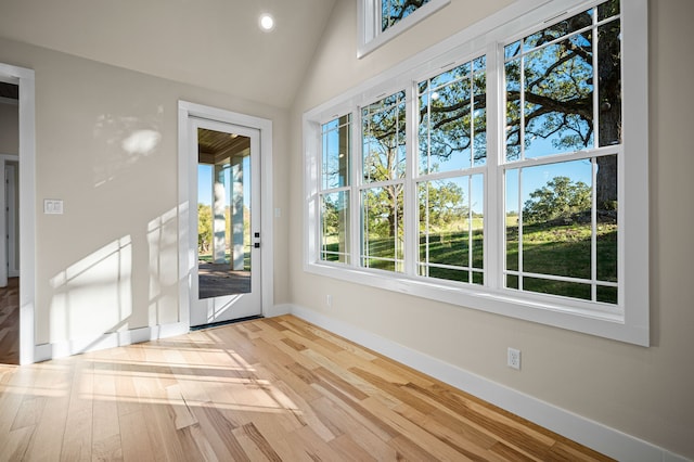 interior space with vaulted ceiling and light hardwood / wood-style flooring