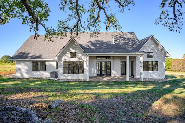 rear view of house with a yard and a patio