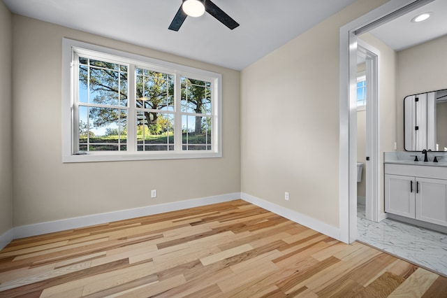 empty room featuring light wood-type flooring and ceiling fan