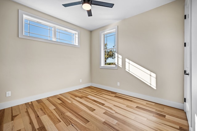 empty room with light wood-type flooring and ceiling fan