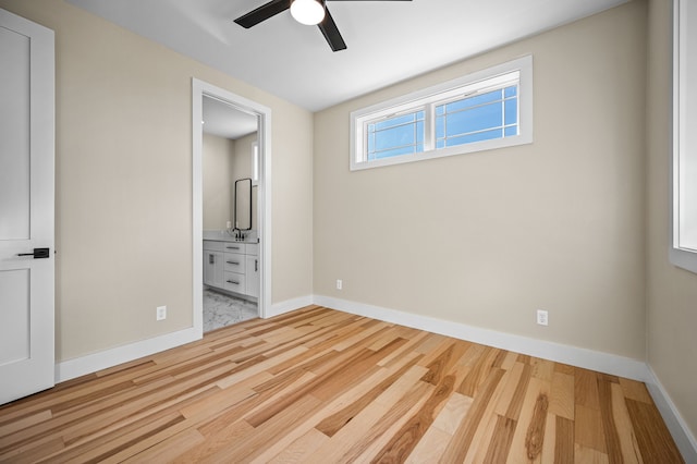 unfurnished bedroom with connected bathroom, ceiling fan, and light hardwood / wood-style floors