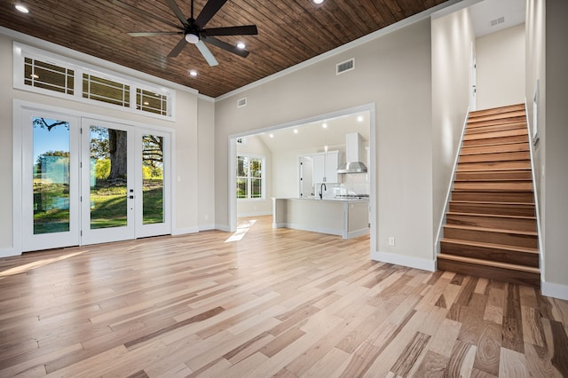 unfurnished living room with ceiling fan, light hardwood / wood-style floors, wood ceiling, and crown molding