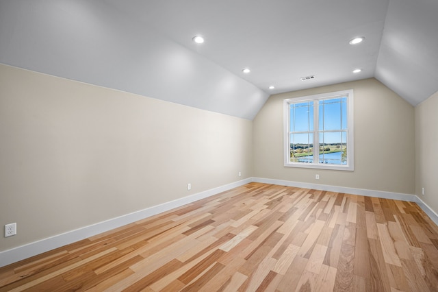 bonus room featuring light hardwood / wood-style floors and vaulted ceiling