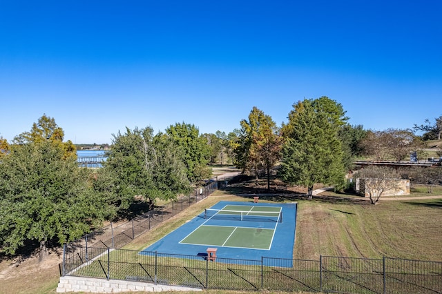 view of tennis court with a lawn