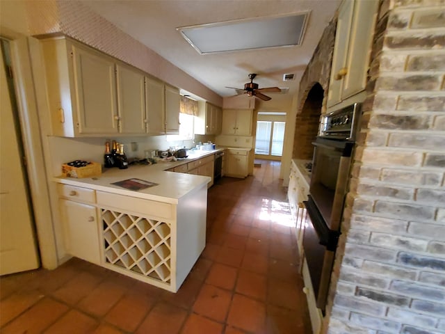 kitchen featuring ceiling fan, cream cabinets, light tile patterned flooring, and black appliances