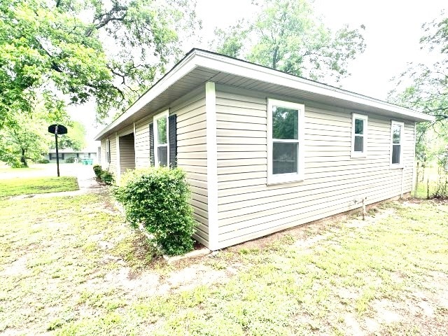 view of home's exterior with a lawn