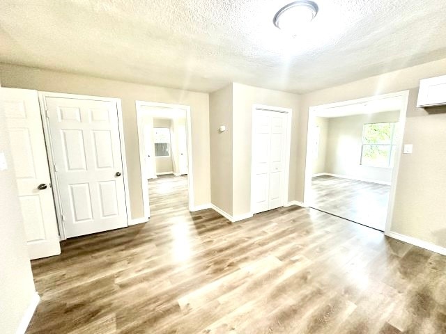 unfurnished bedroom featuring hardwood / wood-style floors and a textured ceiling