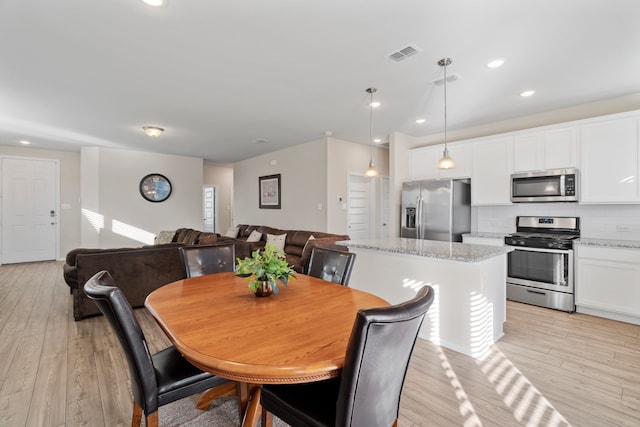 dining space with light wood-type flooring