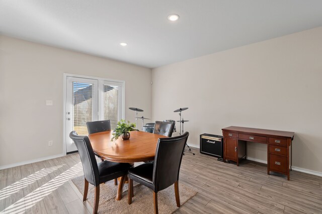 dining space with light wood-style floors, baseboards, and recessed lighting