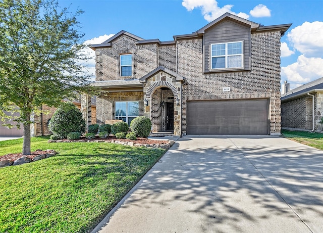 view of front of house featuring a front yard and a garage