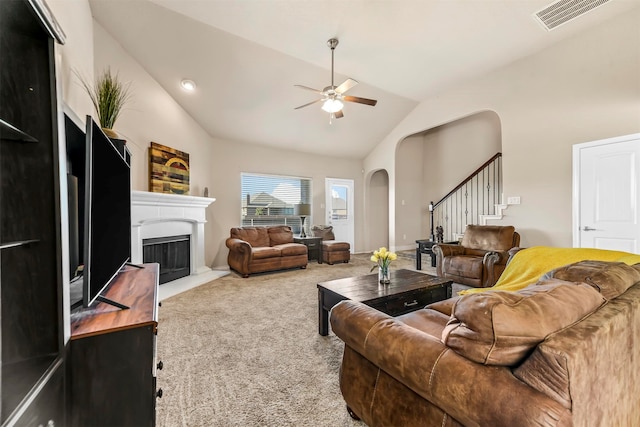 carpeted living room featuring ceiling fan and vaulted ceiling