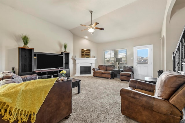 carpeted living room with ceiling fan and lofted ceiling