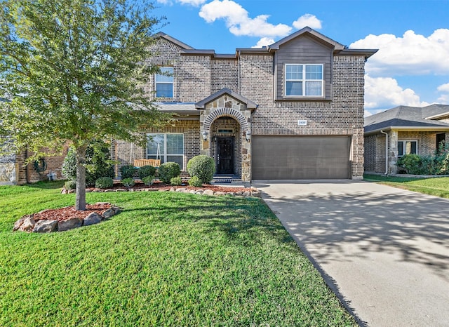 view of front of home with a front lawn and a garage