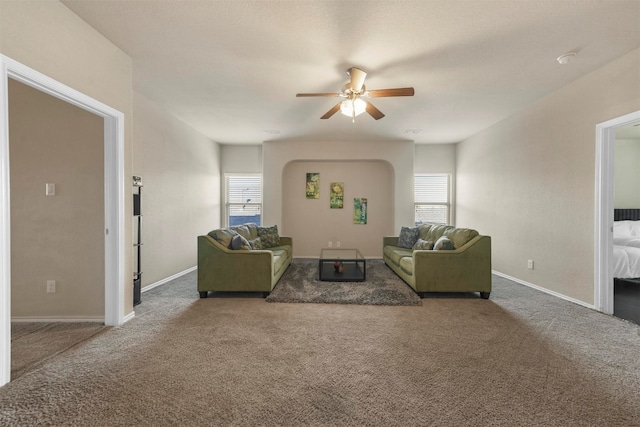 living room featuring carpet and ceiling fan