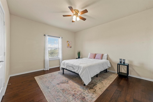 bedroom featuring ceiling fan and dark wood-type flooring