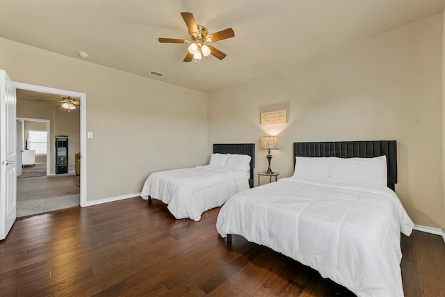 bedroom featuring ceiling fan and dark wood-type flooring