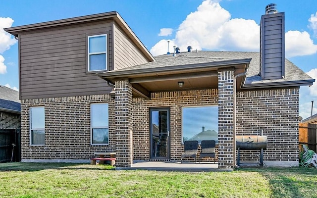 back of house with a lawn and a patio area