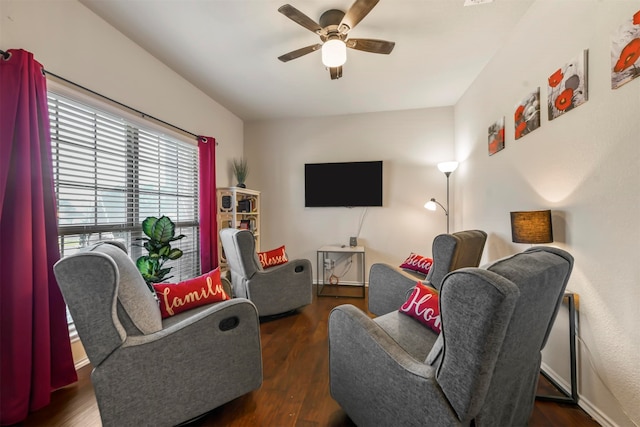 living room with ceiling fan and dark hardwood / wood-style floors