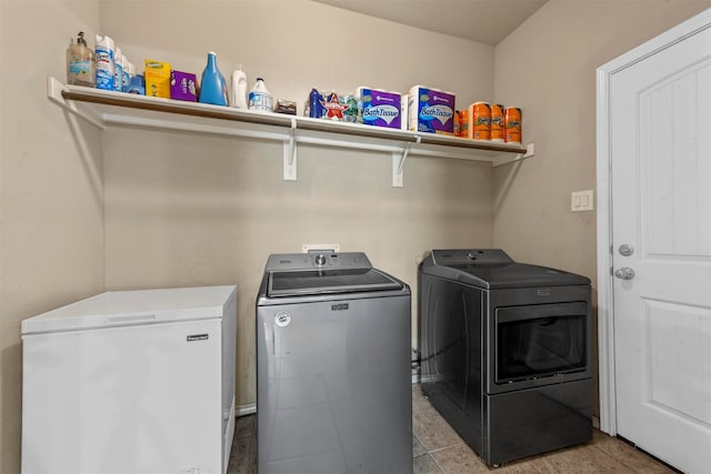 washroom with washing machine and clothes dryer