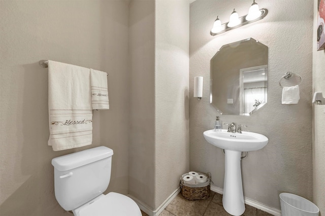 bathroom with tile patterned floors, sink, and toilet