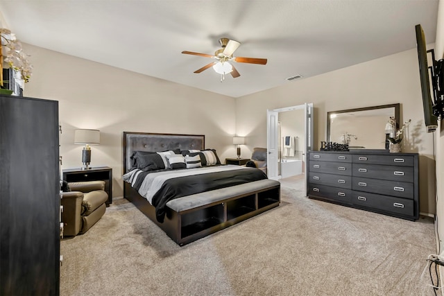 carpeted bedroom with ceiling fan and ensuite bath