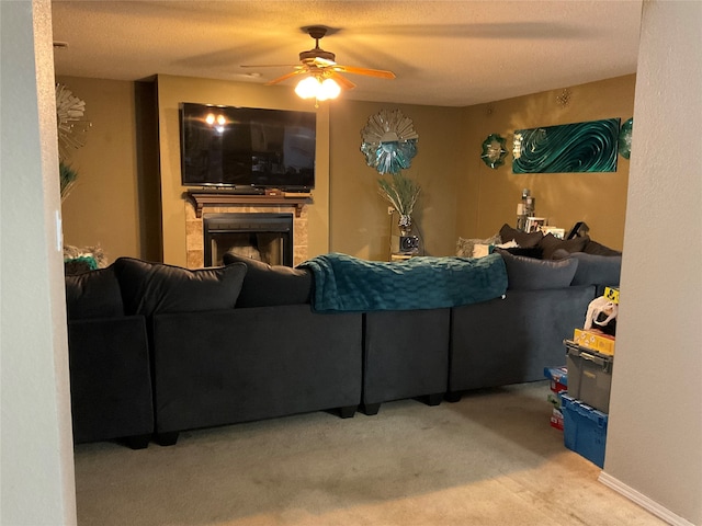 living room with carpet flooring, ceiling fan, and a textured ceiling