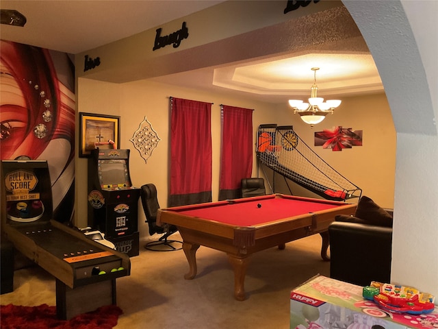 recreation room with a tray ceiling, billiards, carpet, and a notable chandelier