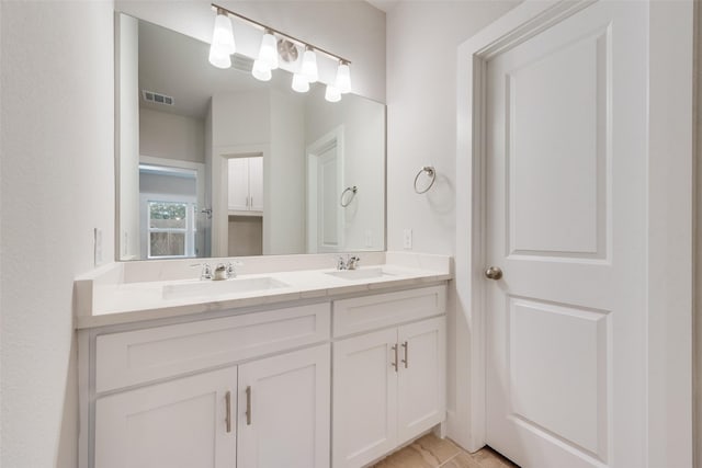 bathroom with tile patterned floors and vanity