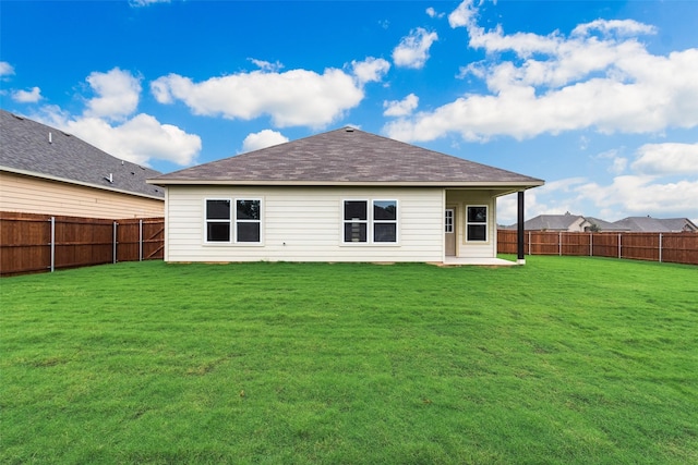 rear view of property with a lawn