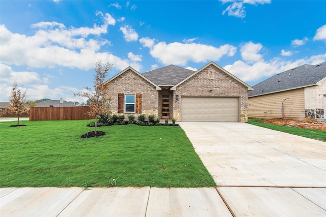 view of front of property with a front yard and a garage