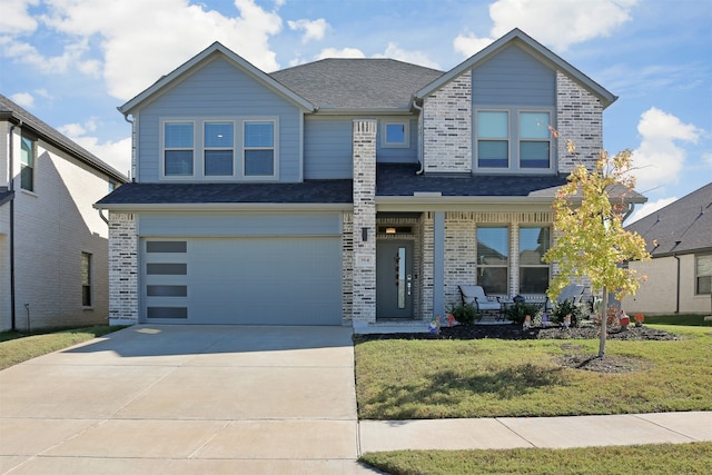 view of front of home featuring a porch, a garage, and a front yard