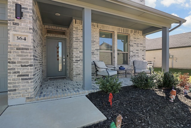 view of exterior entry featuring covered porch