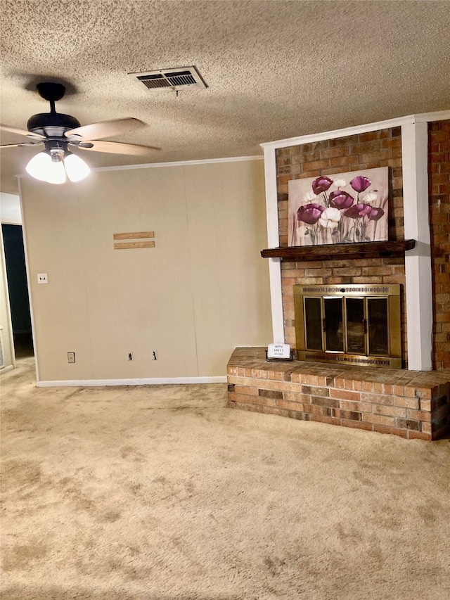 unfurnished living room with crown molding, carpet, a textured ceiling, and a brick fireplace